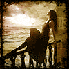 Аватар Девушка сидит на парапете и смотрит на закат над морем